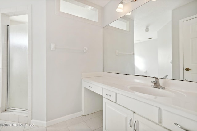 bathroom with vanity, walk in shower, and tile patterned floors