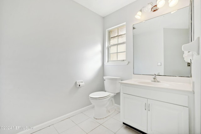 bathroom with vanity, toilet, and tile patterned floors