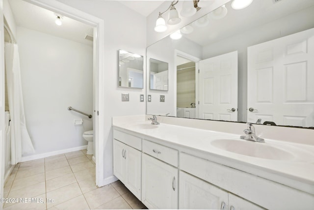 bathroom featuring toilet, vanity, and tile patterned floors