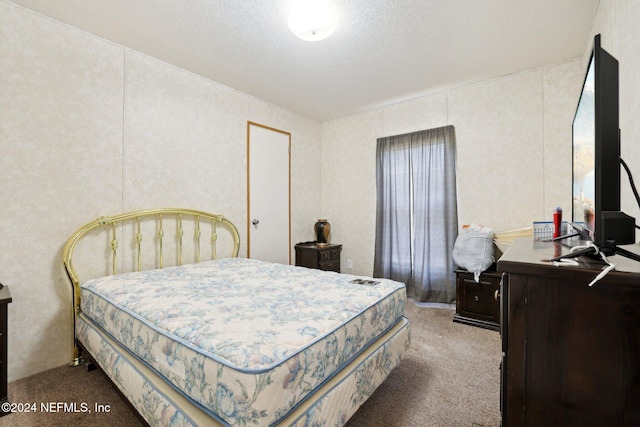 carpeted bedroom with a textured ceiling