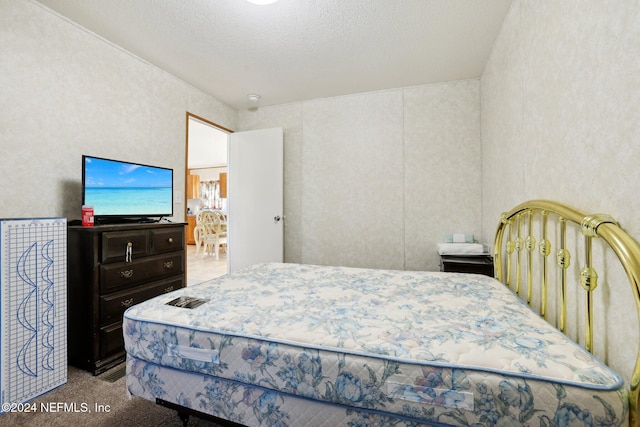 carpeted bedroom featuring a textured ceiling