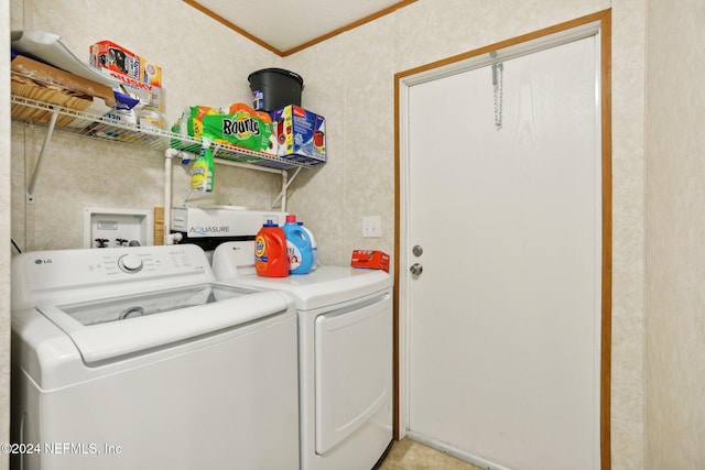 laundry area featuring ornamental molding and separate washer and dryer