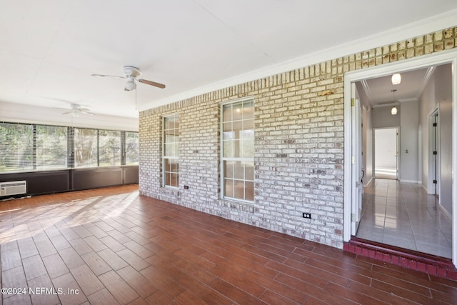 unfurnished sunroom with a wall mounted AC and ceiling fan