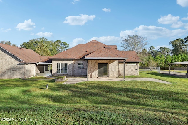 back of house with a yard and a patio area