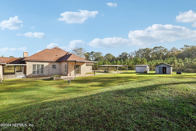 back of house featuring a patio, a storage shed, and a lawn