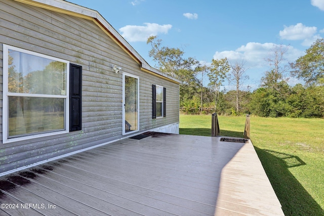 wooden terrace featuring a yard