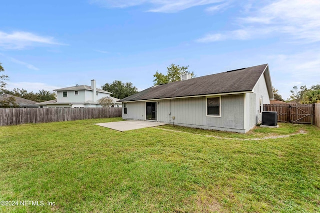 rear view of house featuring a lawn and a patio area