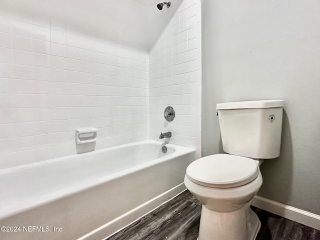 bathroom with toilet, hardwood / wood-style flooring, and tub / shower combination