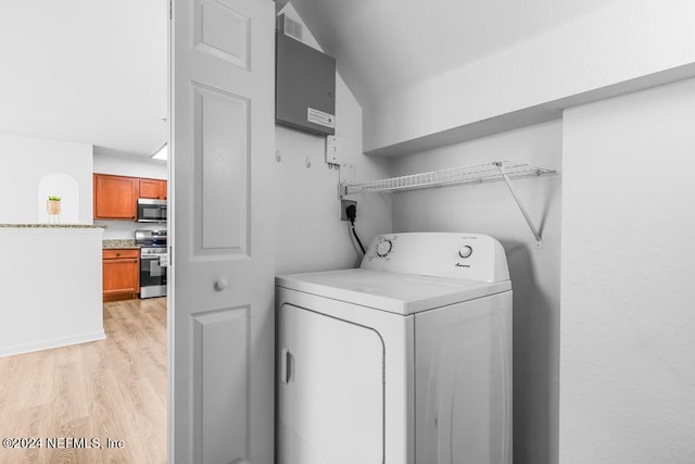 laundry area featuring washer / dryer and light hardwood / wood-style flooring