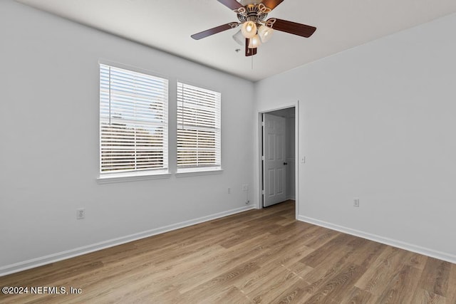 unfurnished room featuring light hardwood / wood-style flooring, a healthy amount of sunlight, and ceiling fan