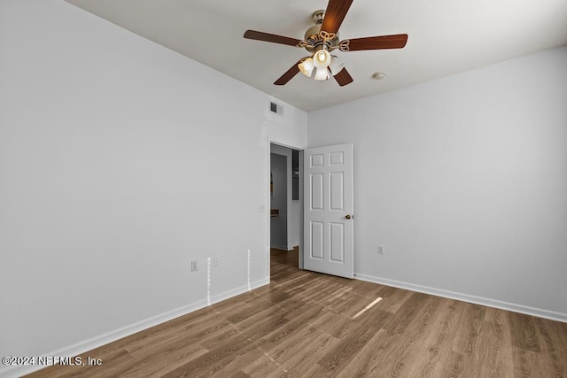 empty room featuring hardwood / wood-style flooring and ceiling fan