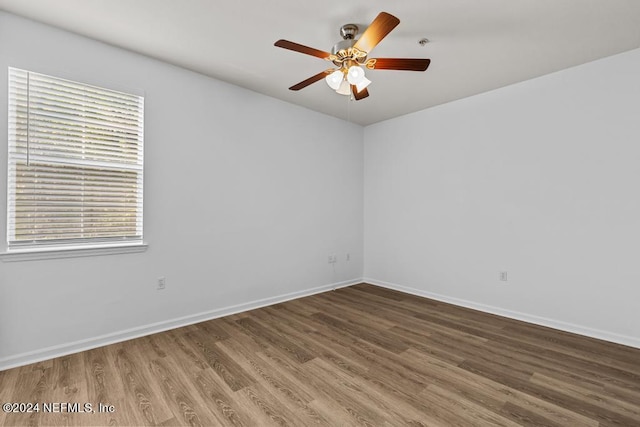 spare room featuring wood-type flooring and ceiling fan