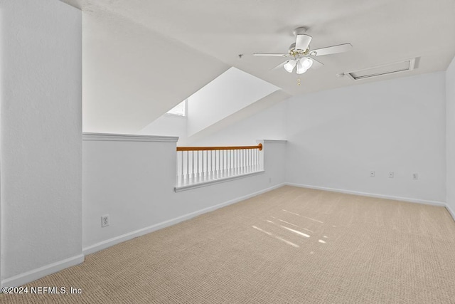 additional living space featuring lofted ceiling, light colored carpet, and ceiling fan