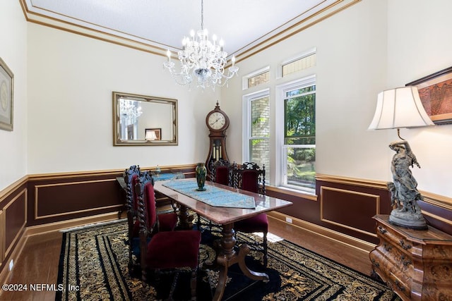 dining room featuring ornamental molding, hardwood / wood-style flooring, and a chandelier