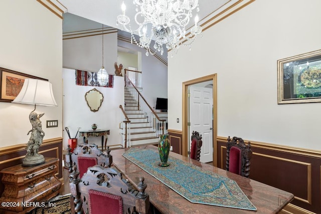 dining room with an inviting chandelier and a high ceiling