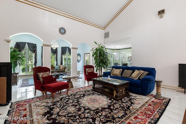 tiled living room with ornamental molding, high vaulted ceiling, and ornate columns