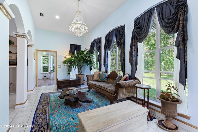 living area featuring a healthy amount of sunlight, light tile patterned floors, and a chandelier