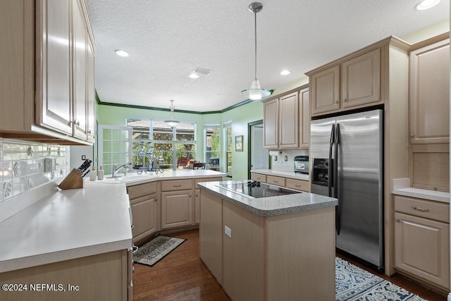 kitchen featuring a kitchen island, black electric stovetop, stainless steel fridge, decorative light fixtures, and dark hardwood / wood-style flooring