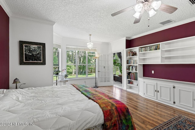 bedroom with ornamental molding, ceiling fan, a textured ceiling, and dark hardwood / wood-style flooring