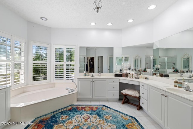 bathroom with vanity, separate shower and tub, a textured ceiling, and tile patterned floors