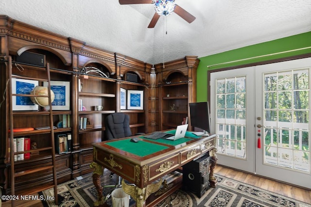 recreation room featuring french doors, hardwood / wood-style floors, a textured ceiling, and ceiling fan