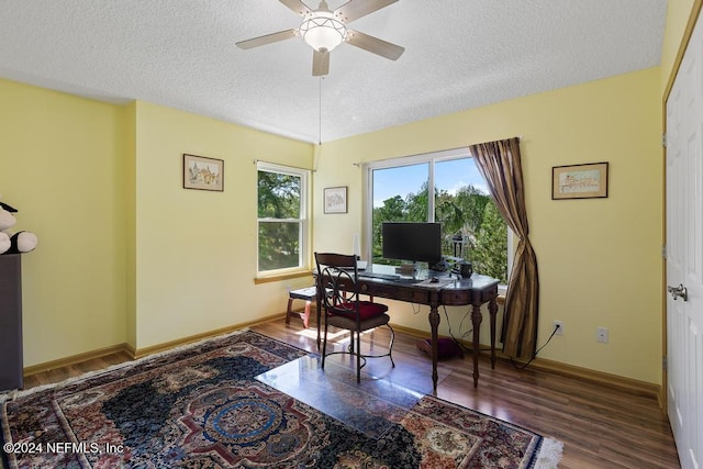 office space featuring ceiling fan, a textured ceiling, and dark hardwood / wood-style flooring