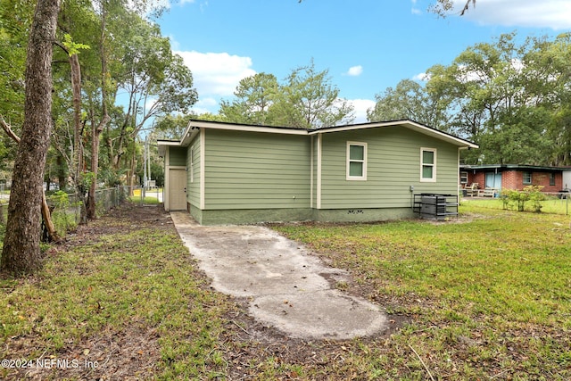 back of house with a lawn