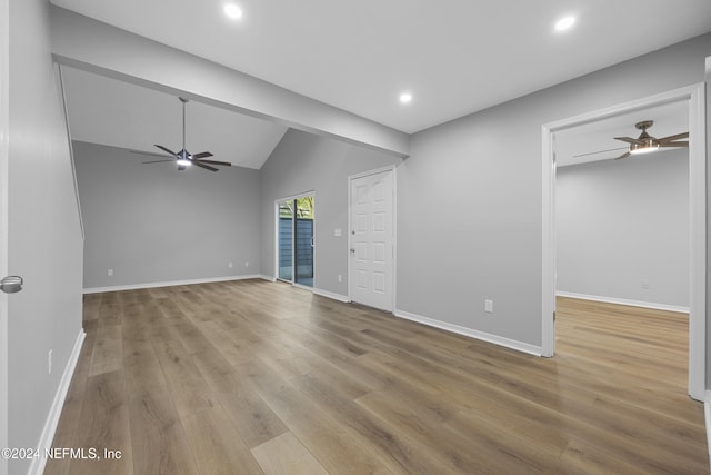 spare room with vaulted ceiling, light hardwood / wood-style flooring, and ceiling fan