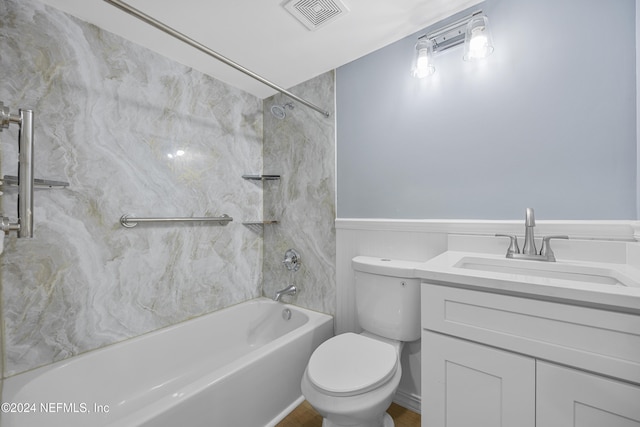 full bathroom with vanity, tiled shower / bath combo, and toilet