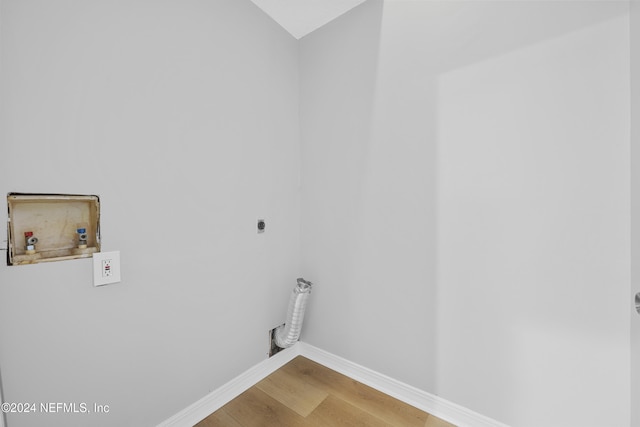 clothes washing area featuring hookup for an electric dryer, hardwood / wood-style flooring, and hookup for a washing machine