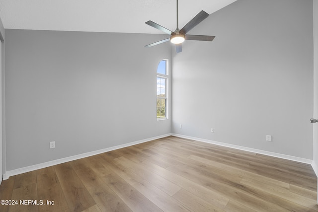 spare room with light wood-type flooring, high vaulted ceiling, and ceiling fan