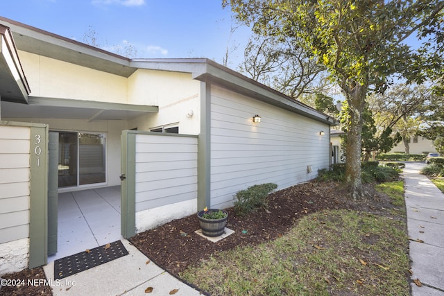 view of side of property featuring a patio area