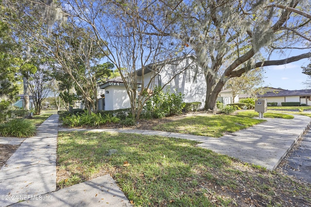 view of side of property with a yard