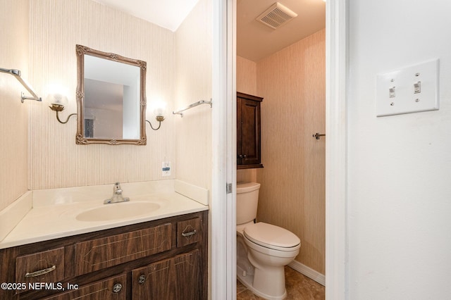 bathroom with toilet and vanity