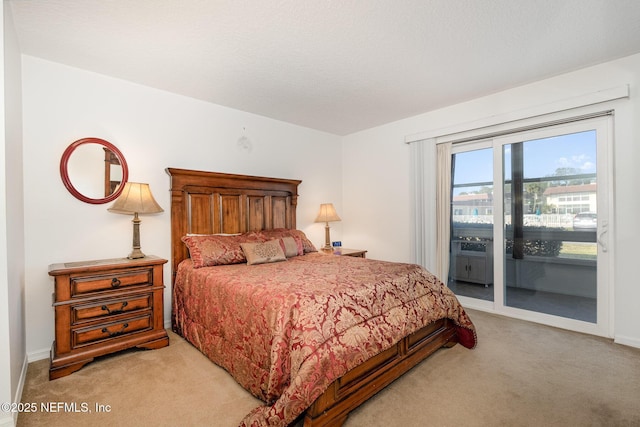 bedroom featuring access to exterior and light carpet