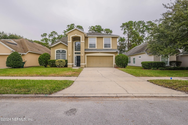 front facade featuring a garage and a front yard