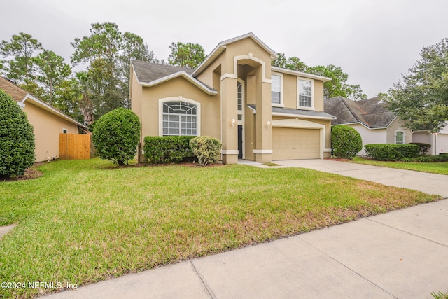 view of front of house with a garage and a front yard