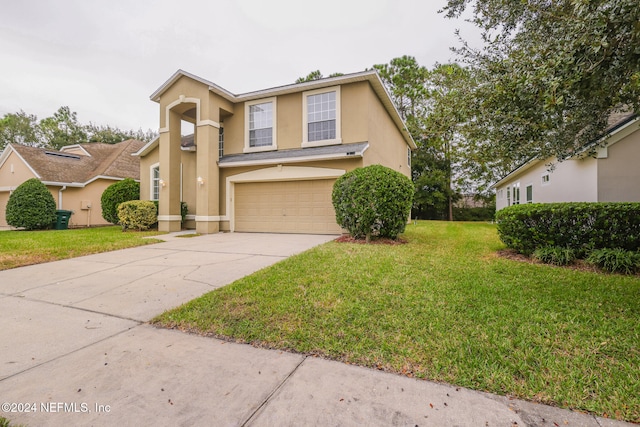 view of front of house featuring a garage and a front yard