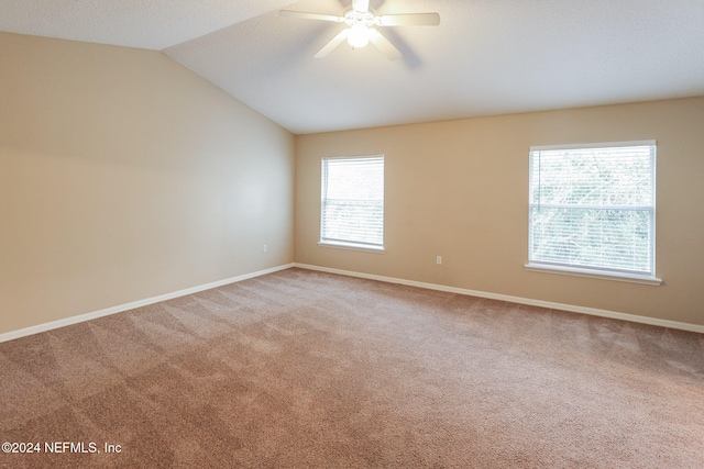 unfurnished room featuring ceiling fan, lofted ceiling, and carpet