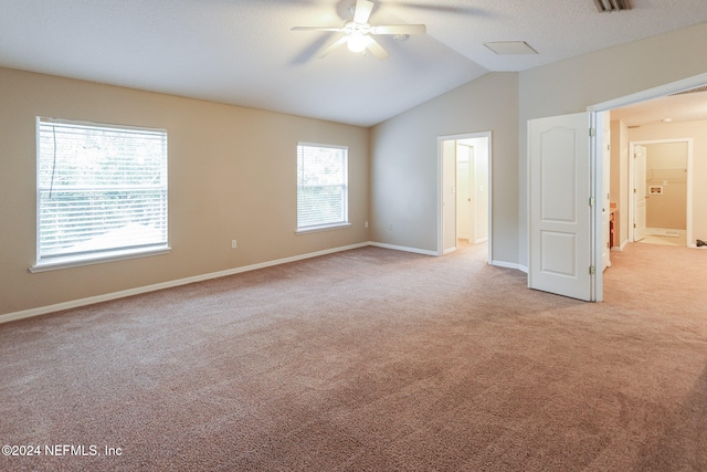 carpeted empty room with ceiling fan and lofted ceiling