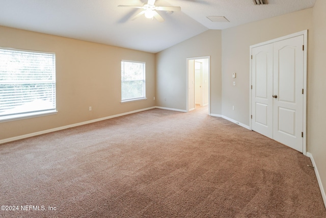 empty room featuring carpet, lofted ceiling, and ceiling fan