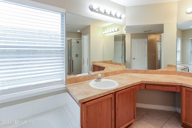 bathroom featuring tile patterned floors, vanity, and a shower with door