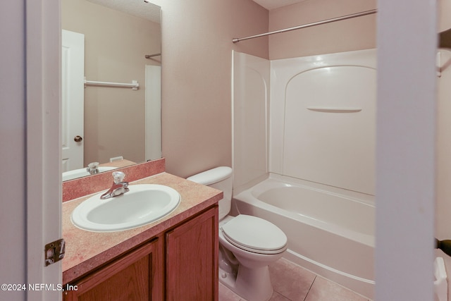 full bathroom featuring toilet, vanity, tile patterned floors, and shower / washtub combination