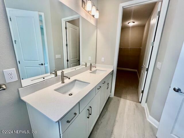 bathroom featuring vanity and hardwood / wood-style floors