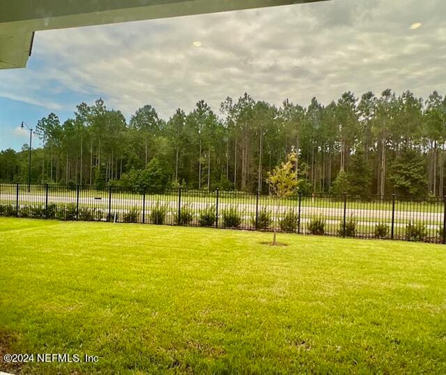 view of home's community with a yard