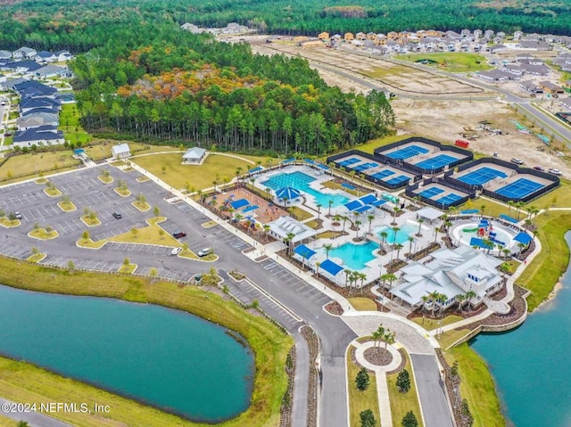 birds eye view of property with a water view