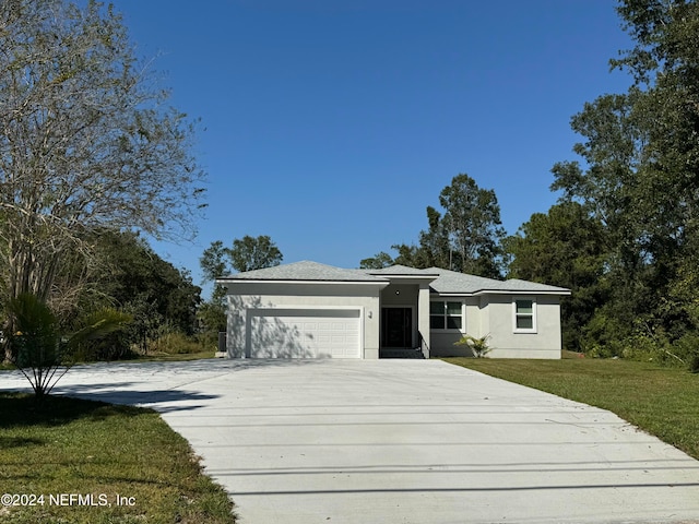 view of front of property with a front yard and a garage