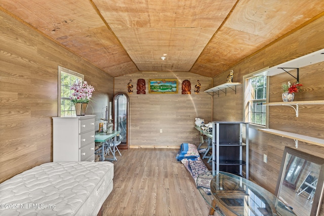 unfurnished bedroom featuring lofted ceiling, wood ceiling, wood-type flooring, and wood walls