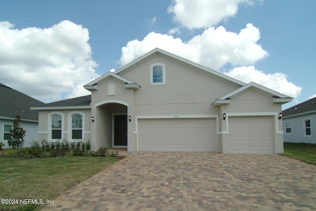 front of property featuring a garage and a front lawn