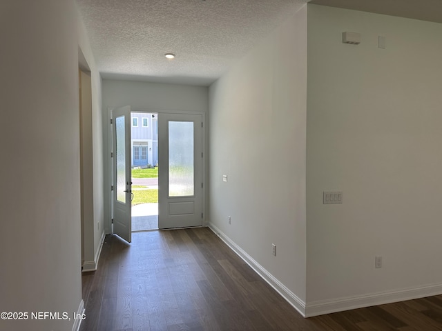 206 Holly Ridge Way, Saint Augustine, FL 32092 - foyer entrance featuring dark wood-style floors, a textured ceiling, and baseboards